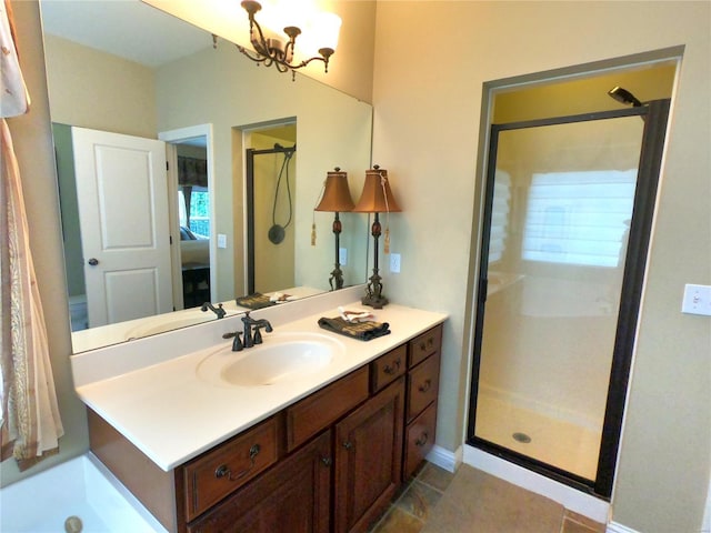 bathroom featuring an enclosed shower, vanity, and an inviting chandelier