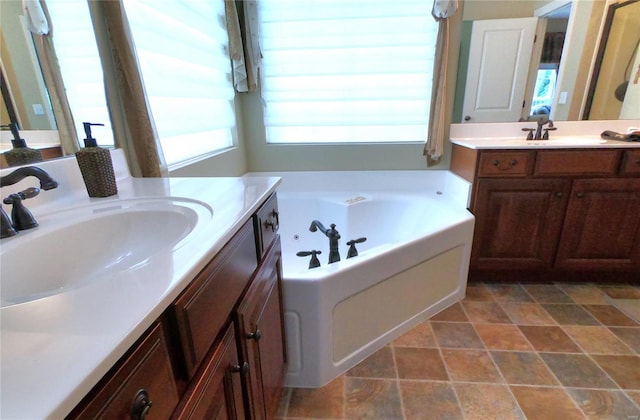 bathroom featuring vanity and a washtub