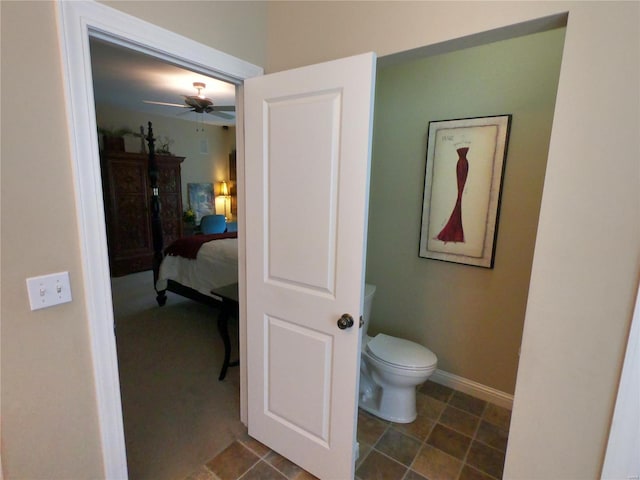 bathroom featuring ceiling fan and toilet