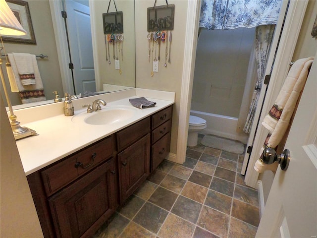 full bathroom with vanity, bathtub / shower combination, and toilet