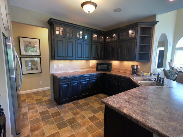 kitchen featuring stainless steel fridge and sink