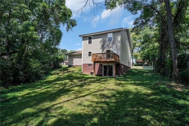 rear view of house with a yard and a wooden deck