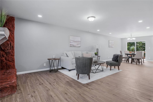 living room featuring a chandelier and light hardwood / wood-style floors