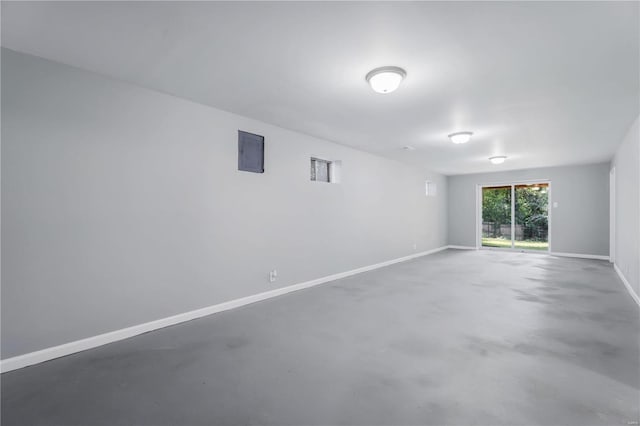 spare room with concrete floors and electric panel