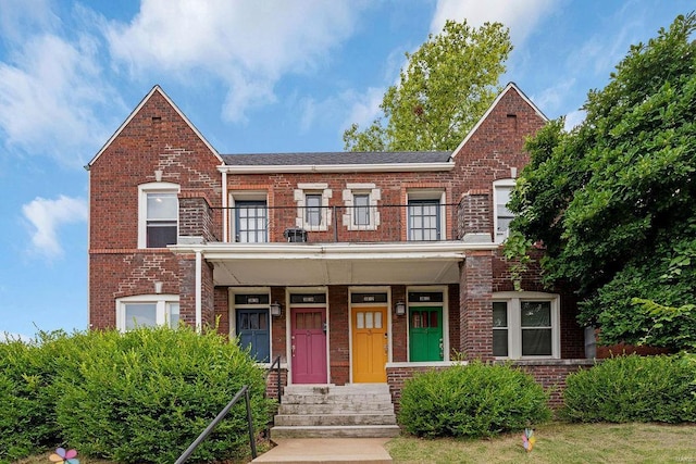 multi unit property with a porch and a balcony