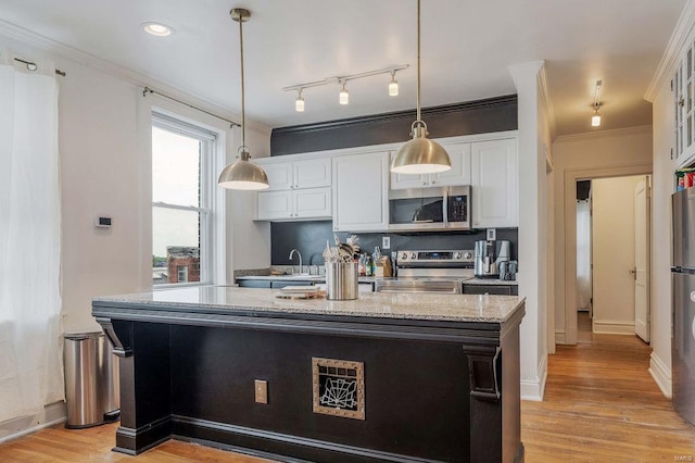 kitchen with white cabinetry, rail lighting, stainless steel appliances, and light hardwood / wood-style floors