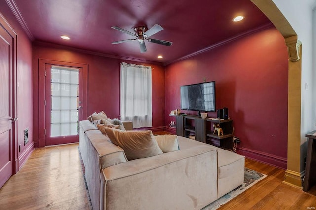 interior space with light wood-type flooring, ceiling fan, and ornamental molding