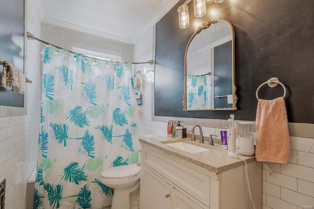 bathroom with vanity, toilet, tile walls, and crown molding