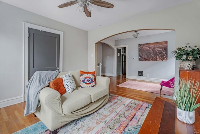 living room featuring hardwood / wood-style floors and ceiling fan