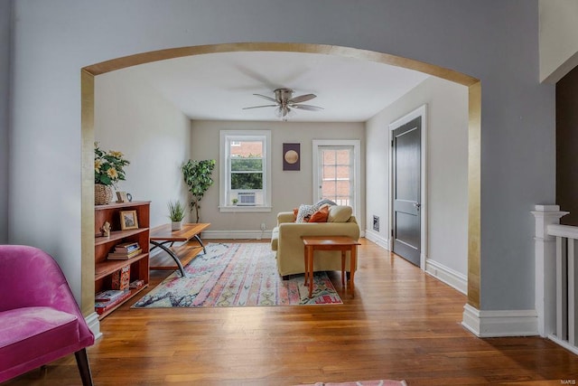 living room with wood-type flooring and ceiling fan