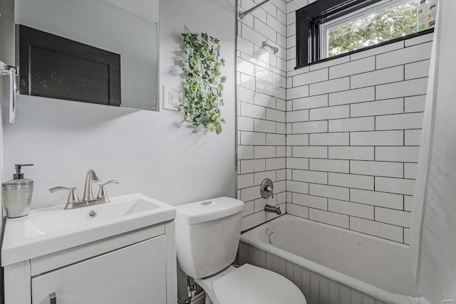 full bathroom featuring tiled shower / bath combo, vanity, and toilet