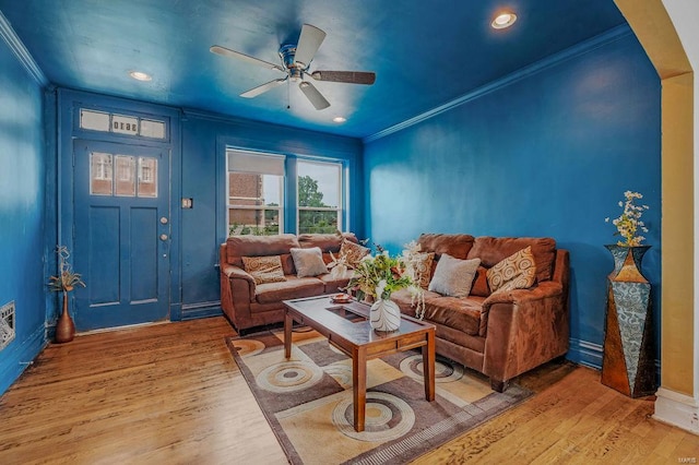 living room with light hardwood / wood-style floors, crown molding, and ceiling fan