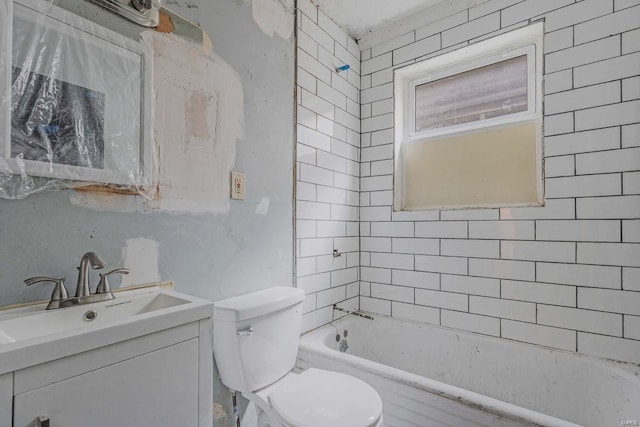 full bathroom with vanity, tiled shower / bath, and toilet