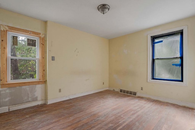 spare room with wood-type flooring