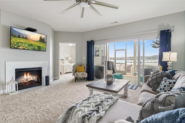 carpeted living room featuring ceiling fan