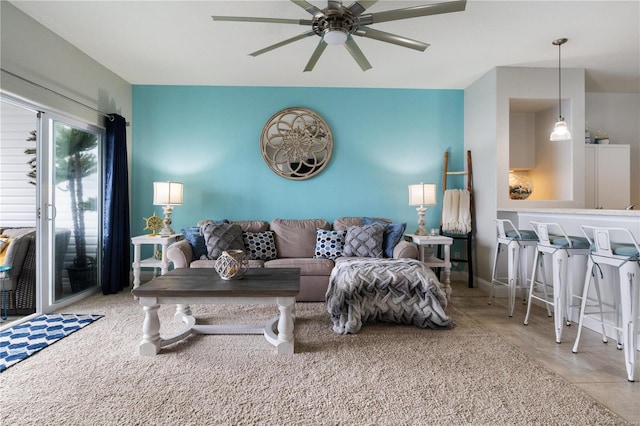 living room with ceiling fan and light tile patterned floors