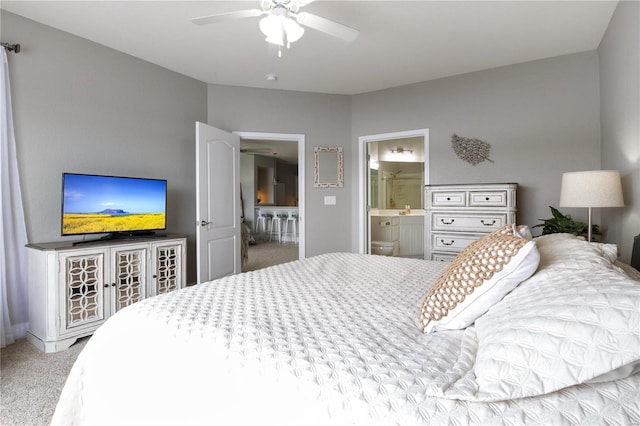 bedroom featuring ensuite bath, ceiling fan, and light colored carpet