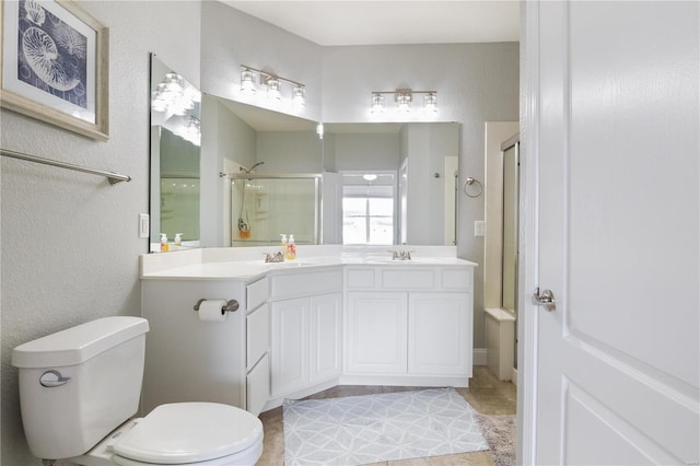 bathroom with tile patterned floors, toilet, and dual bowl vanity