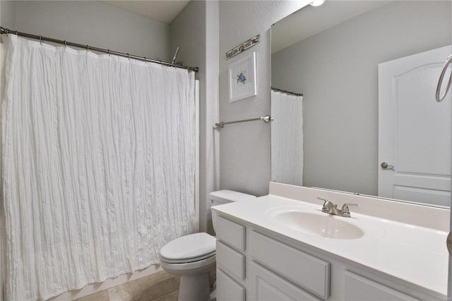 bathroom with tile patterned floors, toilet, and vanity