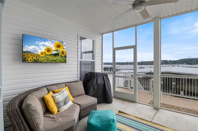 sunroom with a wealth of natural light and ceiling fan