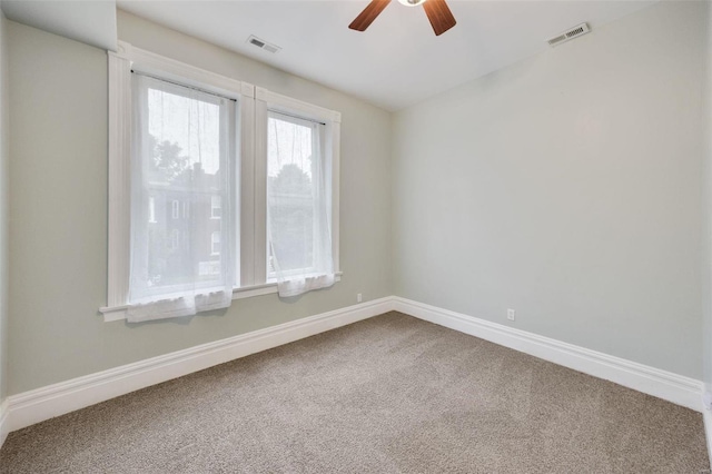 carpeted empty room featuring ceiling fan