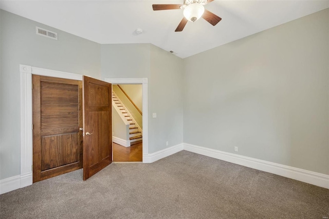 unfurnished bedroom featuring carpet flooring and ceiling fan