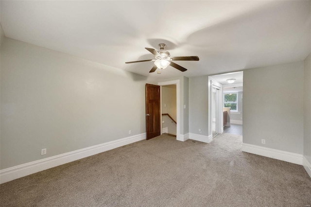 unfurnished room with light carpet and ceiling fan