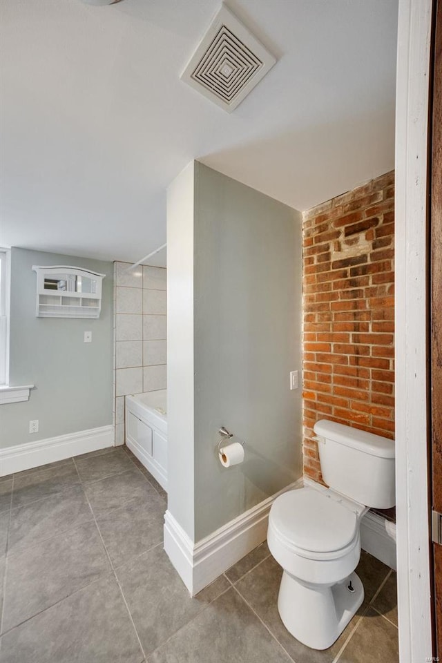 bathroom featuring toilet and tile patterned flooring