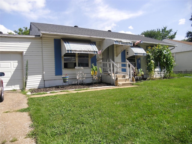 view of front of house featuring a garage and a front lawn