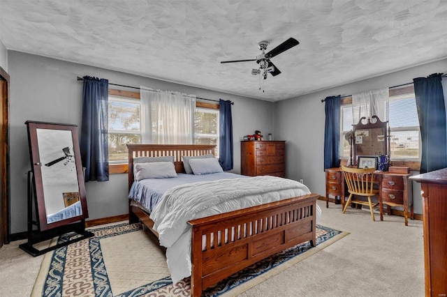 bedroom with carpet floors, a textured ceiling, and ceiling fan