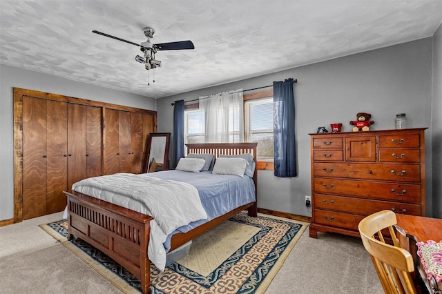 carpeted bedroom with a textured ceiling, ceiling fan, and a closet