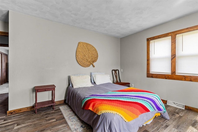 bedroom featuring dark wood-type flooring