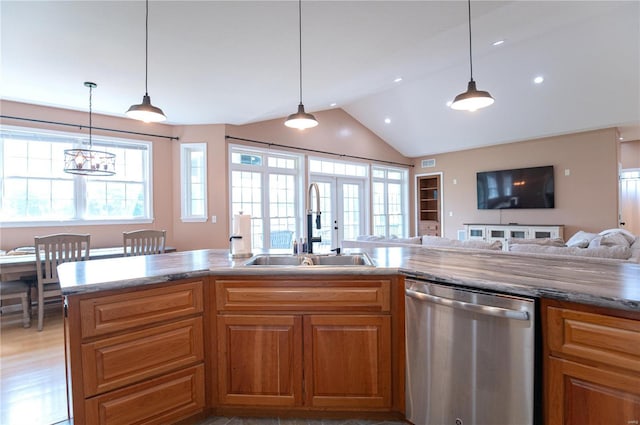 kitchen with pendant lighting, sink, stainless steel dishwasher, and french doors