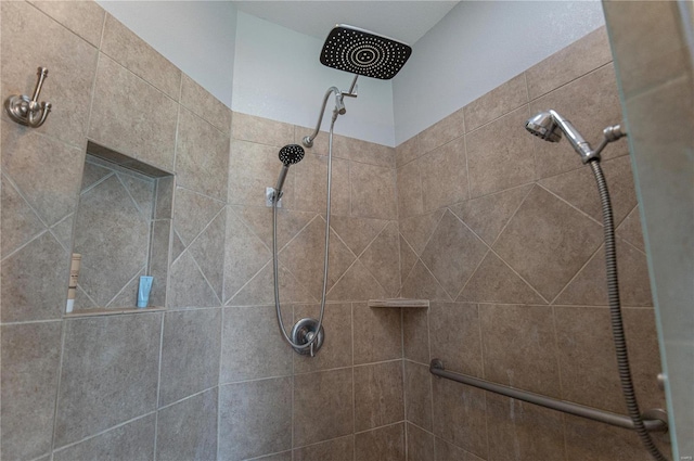 interior details featuring tiled shower