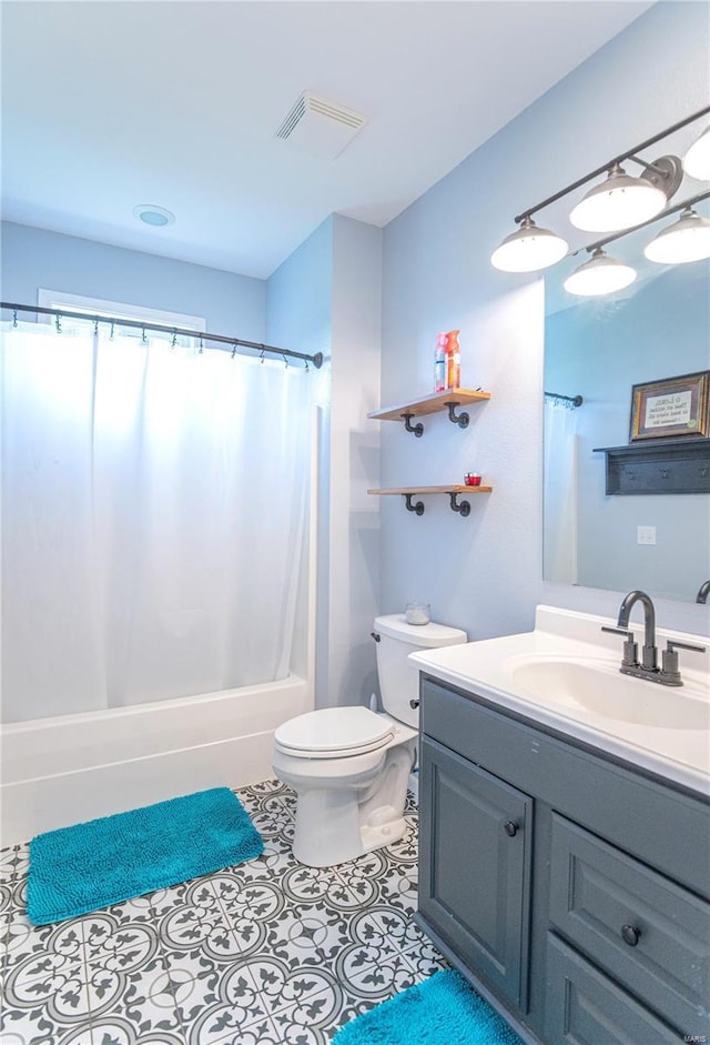 full bathroom featuring tile patterned flooring, vanity, shower / bath combination with curtain, and toilet