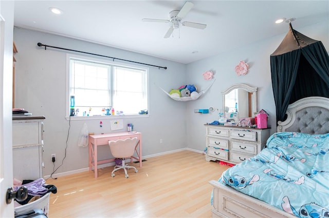 bedroom featuring multiple windows, ceiling fan, and light hardwood / wood-style flooring