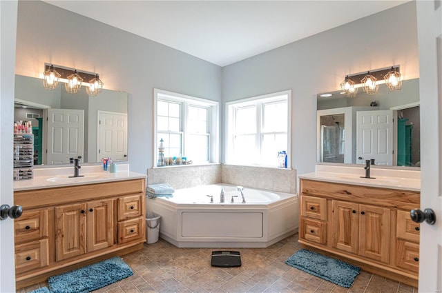 bathroom featuring vanity and separate shower and tub