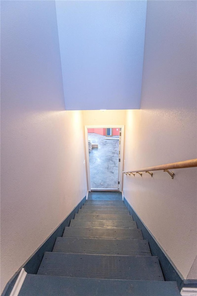 staircase featuring wood-type flooring