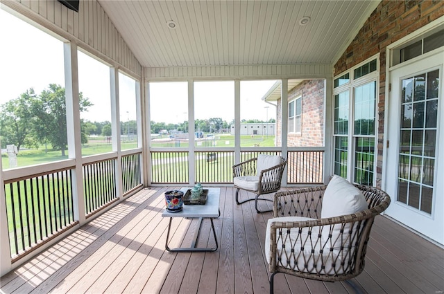 sunroom / solarium featuring lofted ceiling