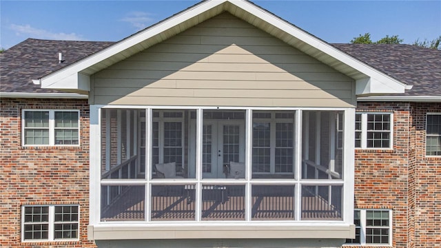 view of side of property featuring a sunroom