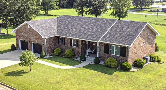 single story home featuring a garage and a front lawn