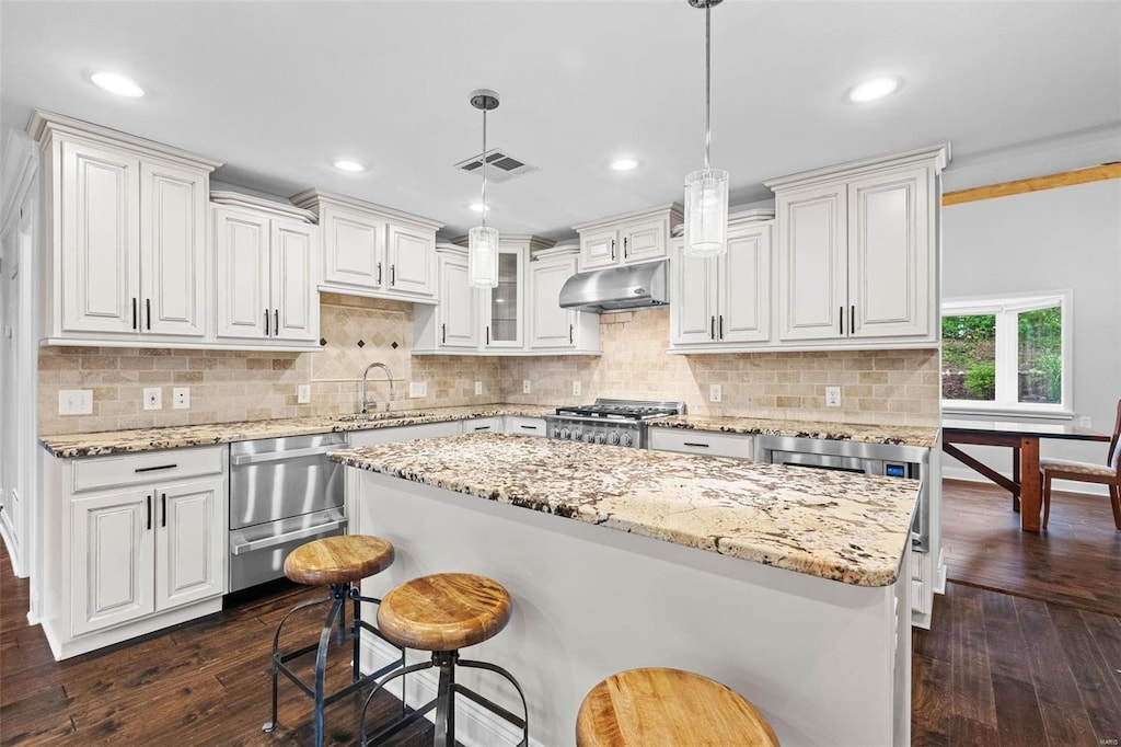 kitchen with white cabinetry, decorative light fixtures, and dark hardwood / wood-style floors