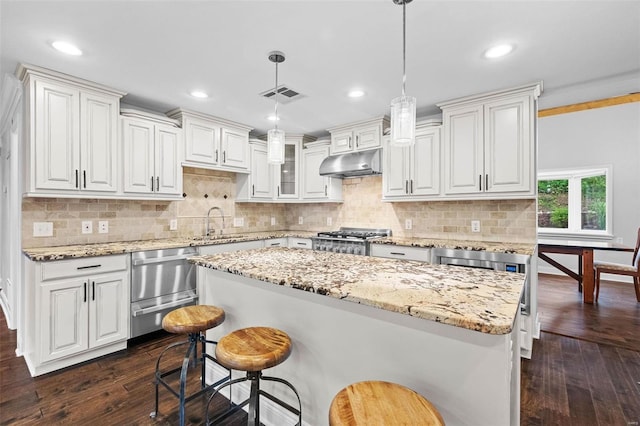 kitchen with white cabinetry, decorative light fixtures, and dark hardwood / wood-style floors