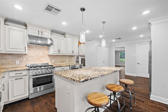 kitchen featuring crown molding, a center island, stainless steel stove, and dark hardwood / wood-style flooring