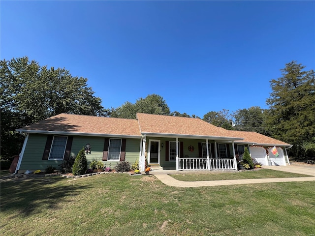 single story home with covered porch, a garage, and a front lawn