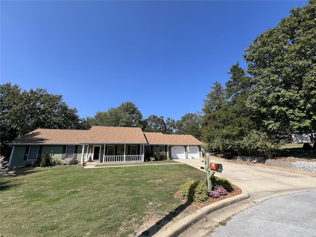 single story home with a porch, a garage, and a front lawn