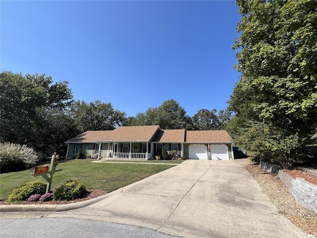 single story home featuring a front lawn, covered porch, and a garage