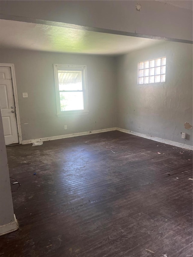 empty room with dark hardwood / wood-style floors