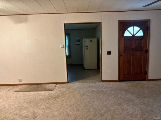 carpeted entryway featuring baseboards