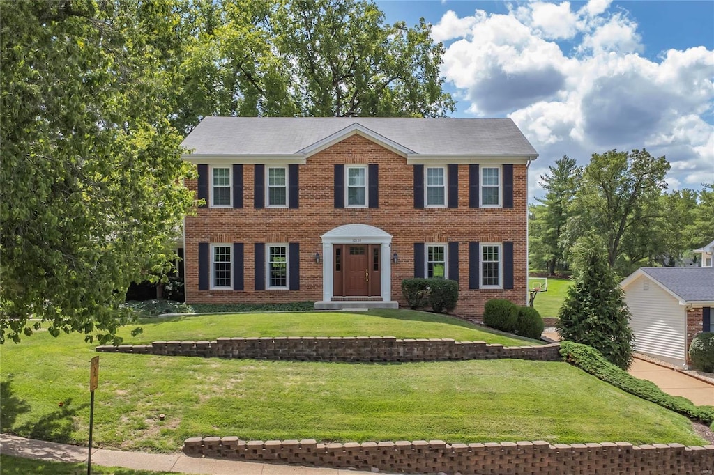 colonial inspired home with a front yard